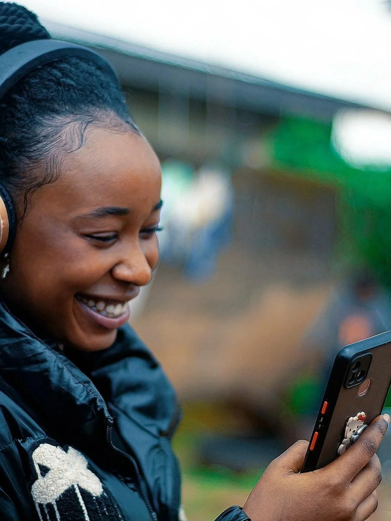 A smiling woman enjoying a joyful message on her phone